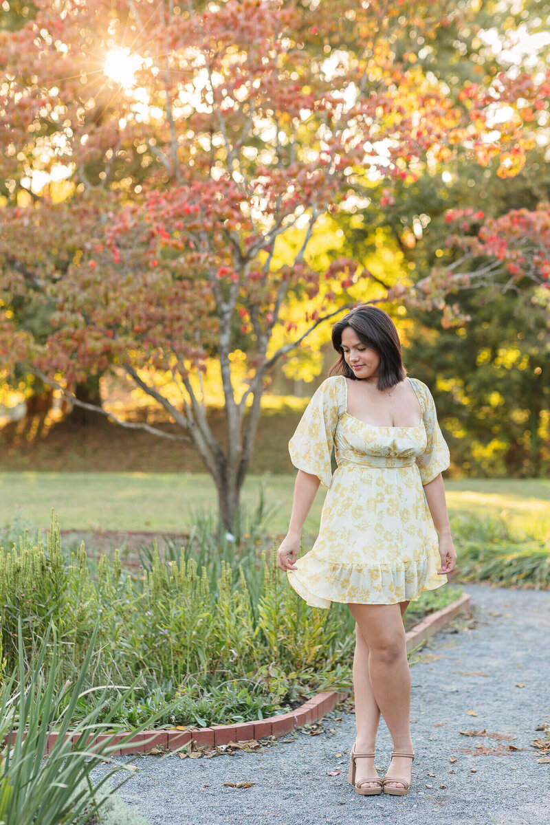 A beautiful young lady in a yellow dress at a Chantilly park at sunset.