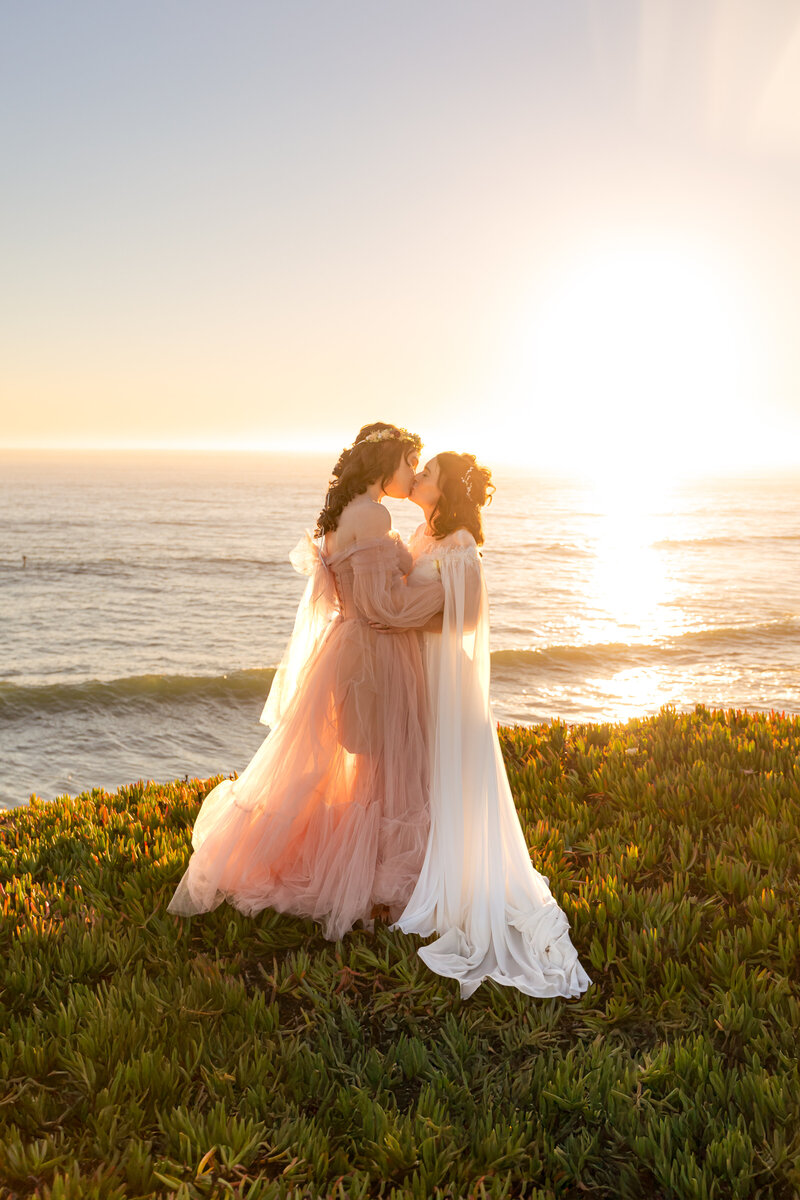 two lesbian brides kissing on santa cruz cliffs