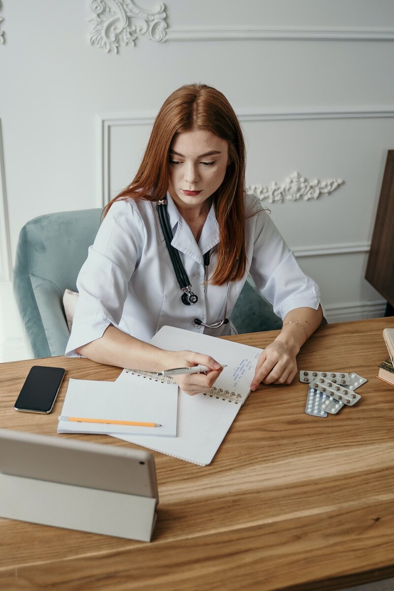 woman at desk writing