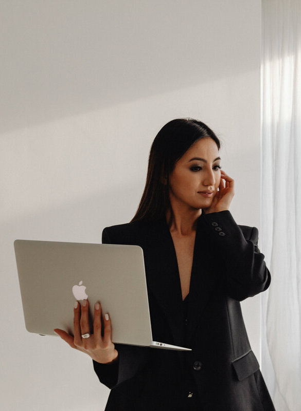 kaboompics_dark-classy-aesthetic-fashion-beautiful-asian-female-entrepreneur-in-black-suit-technology-and-devices-iphone-laptop-airpods-30063