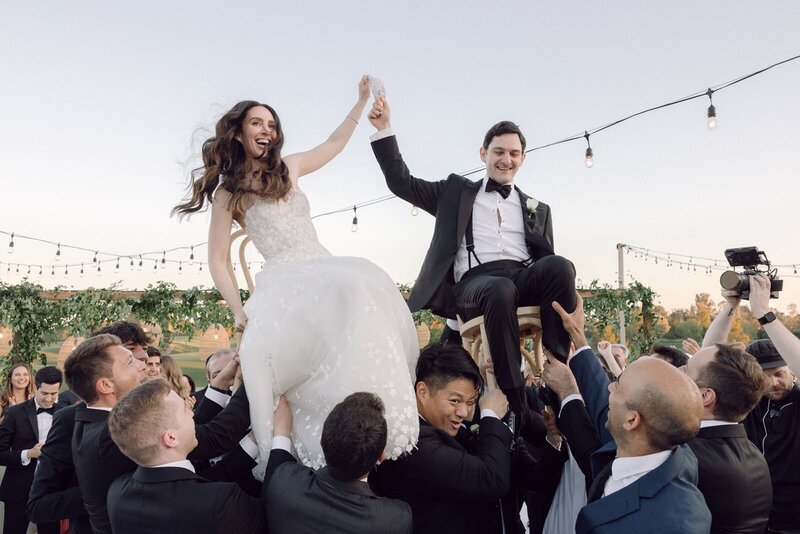 Bride entering the isle with her father through draped wooden doors