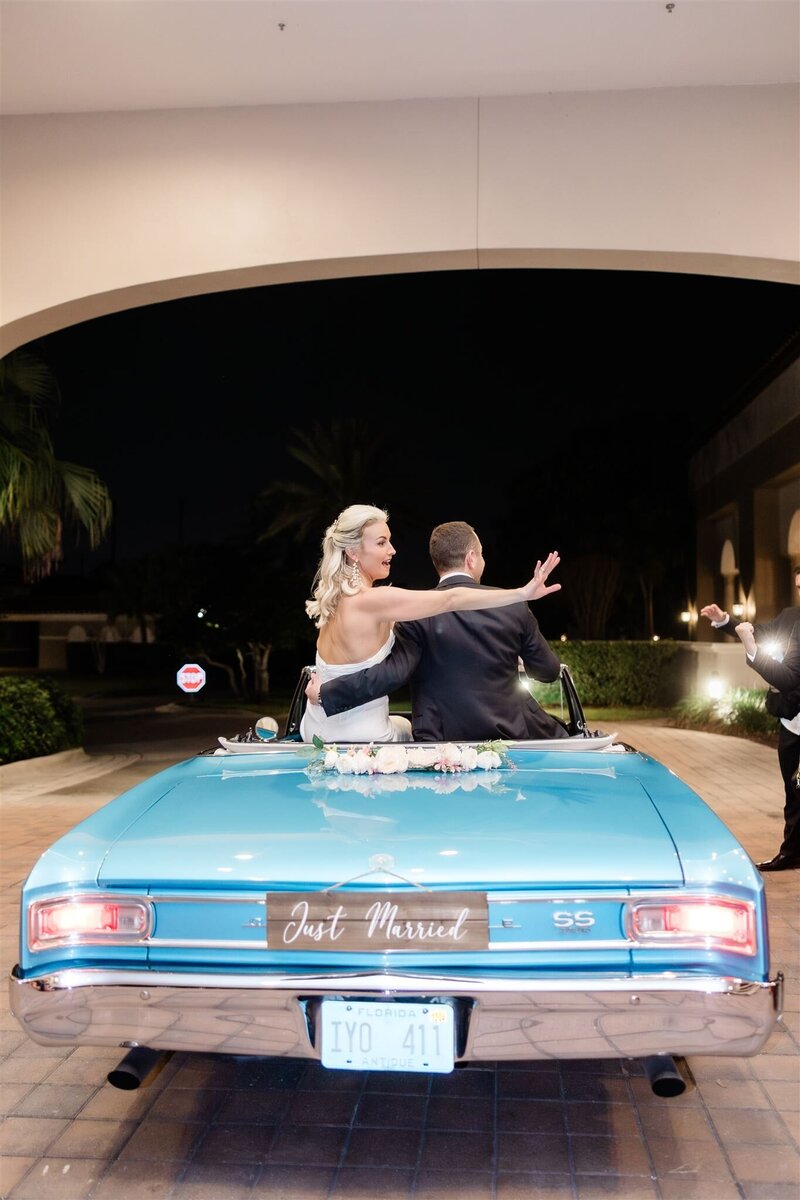 Wedding reception getaway car at the country club of Orlando by orlando wedding photographer 