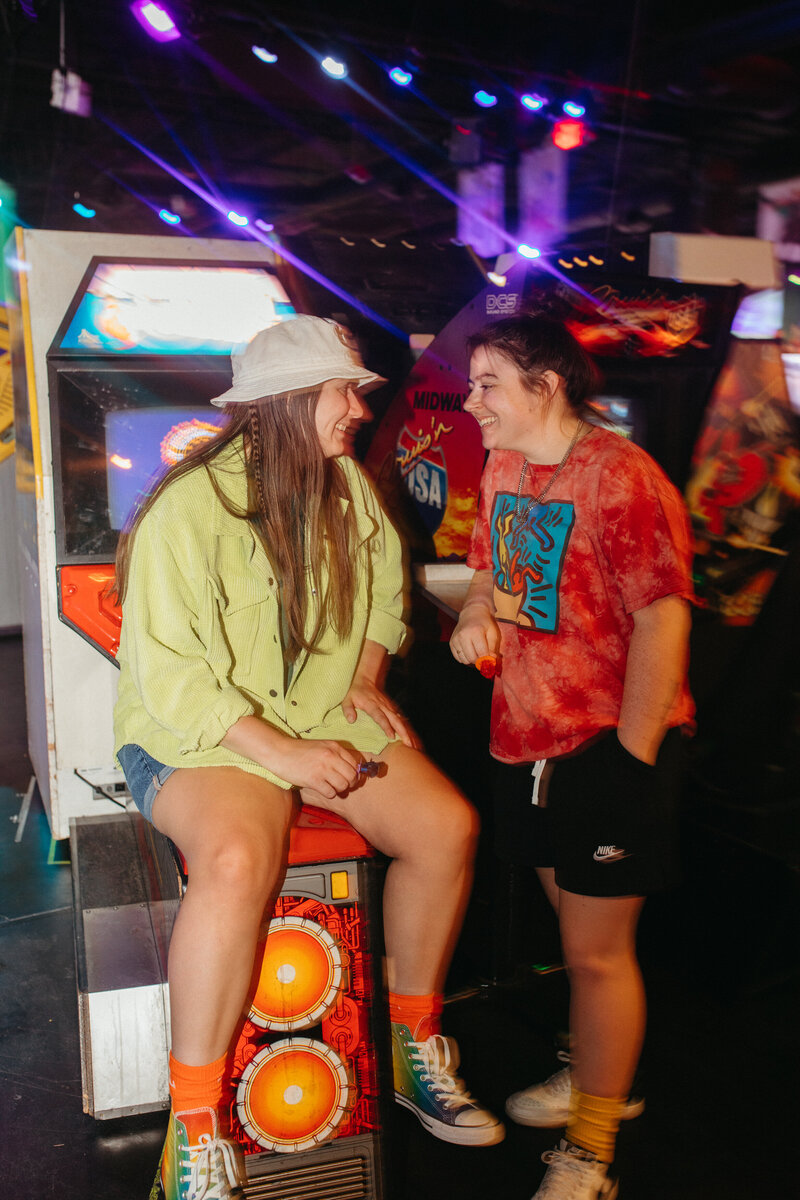 two girls laughing at an arcade