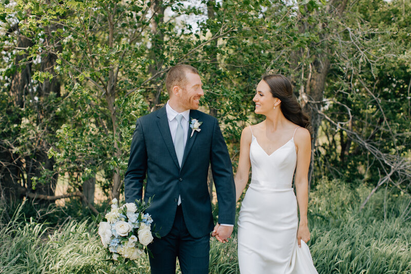 Bride and Groom walk arm in arm back down the aisle after their chic wedding in the midwest. Photo by Anna Brace, who specializes in Omaha Wedding Photography.