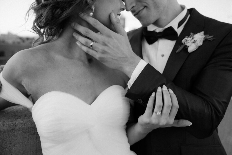 Husband and wife embrace on the rooftop of a building in downtown Nashville, TN. 