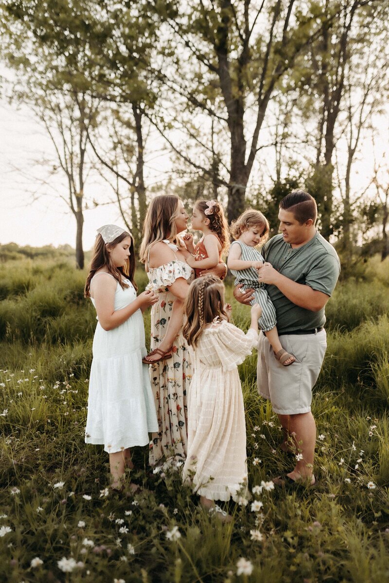 Photographer Kayla Pontier's family standing in a gorgeous meadow.