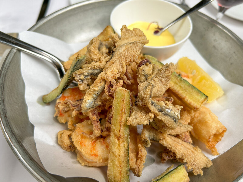 A plate of lightly fried seafood and vegetables at Paper Moon Giardino in Milan, Italy