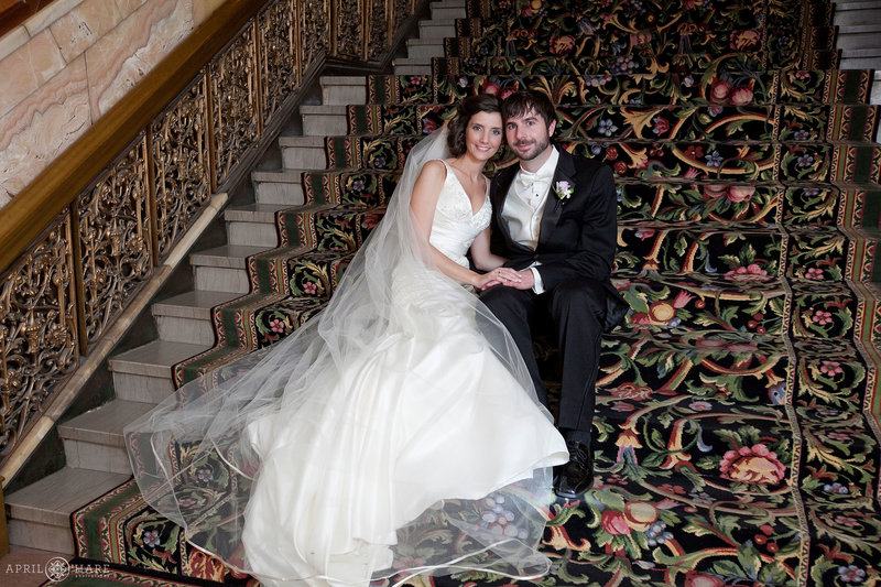 Couple pose on a grand staircase at The Brown Palace Hotel Wedding