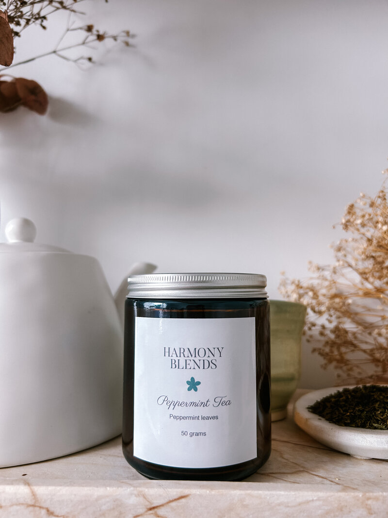 Hayley Founder of Harmony Blends, Holding a fresh brewed tea