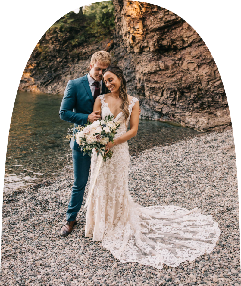 Bride and groom standing on the shore during their elopement