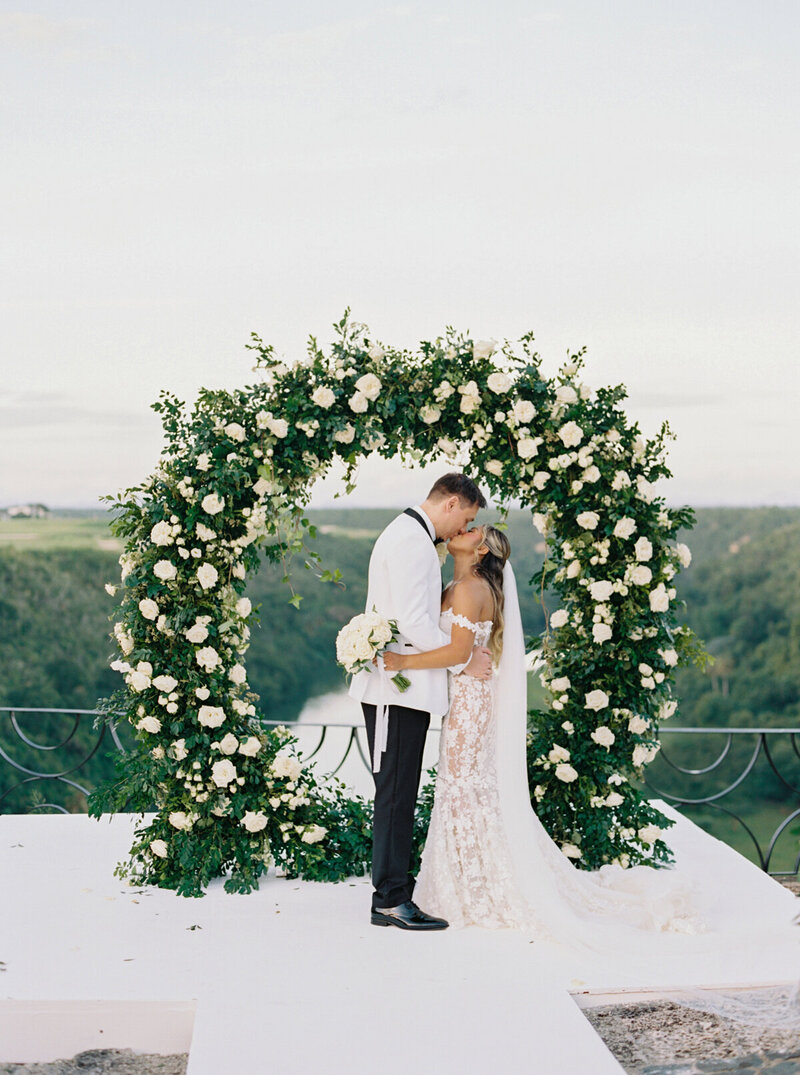 Bride and groom share a kiss during their romantic destination wedding ceremony in the Dominican Republic, captured on film by destination wedding photographer Melissa Piontkowski.