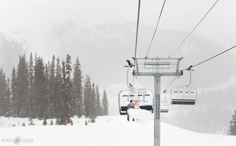 Couple on a ski lift during winter at Arapahoe Basin