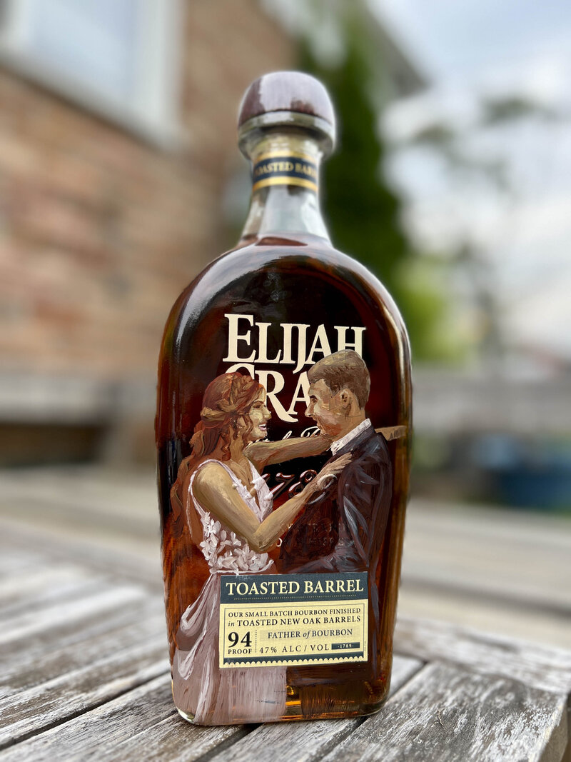 Painted whiskey bottle with bride and groom on it