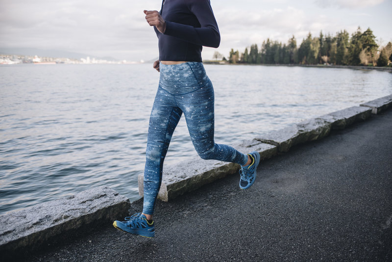 Close up of a females legs wearing tights and running during a clothing brand photoshoot