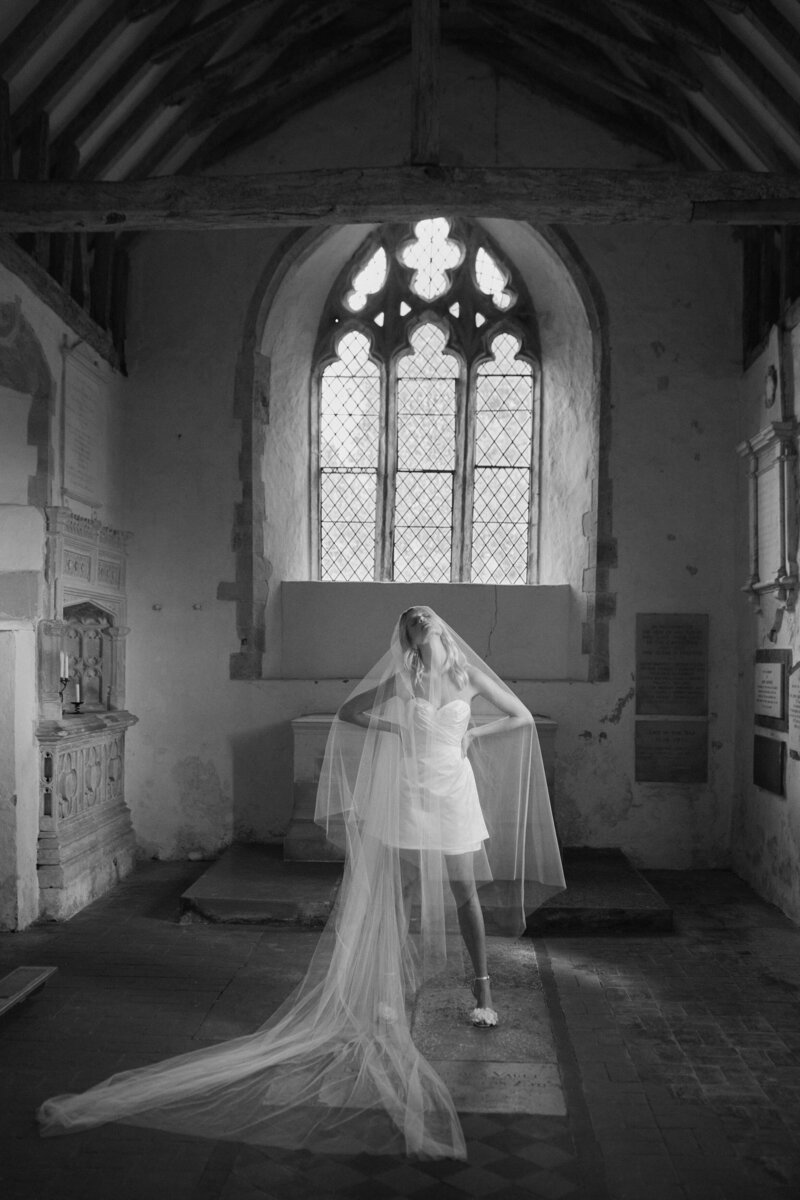 Sleeveless mini wrap wedding dress in sillk worn by bride styled by British wedding dress designer