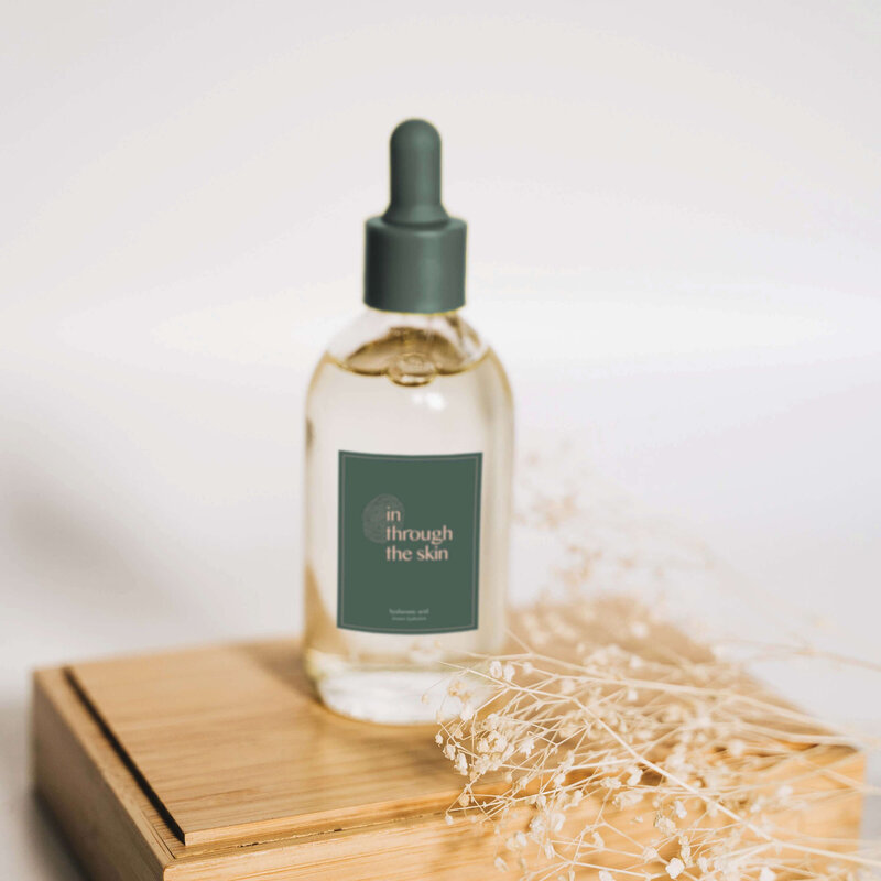 custom packaging design for a holistic skincare brand, featuring deep green and blush tones