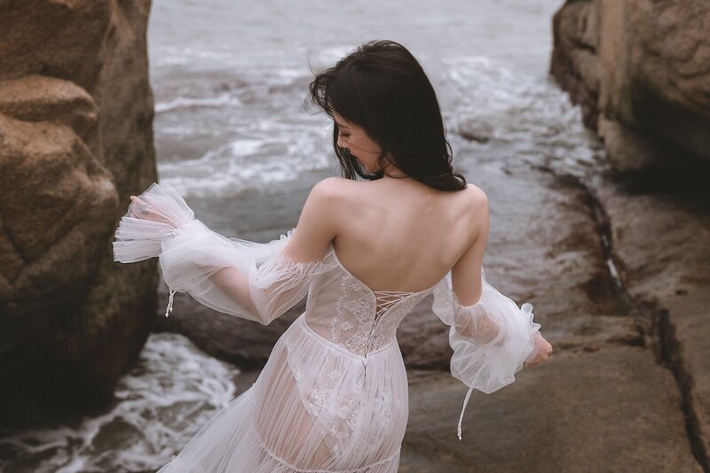 A beautiful windswept beach couture shoot amongst coastal rocks.