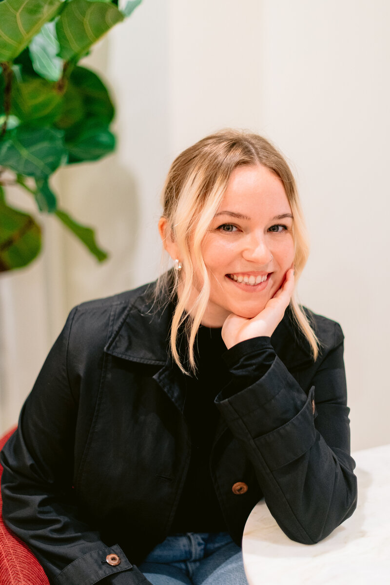 A girl with long brown curly hair smiling at the camera