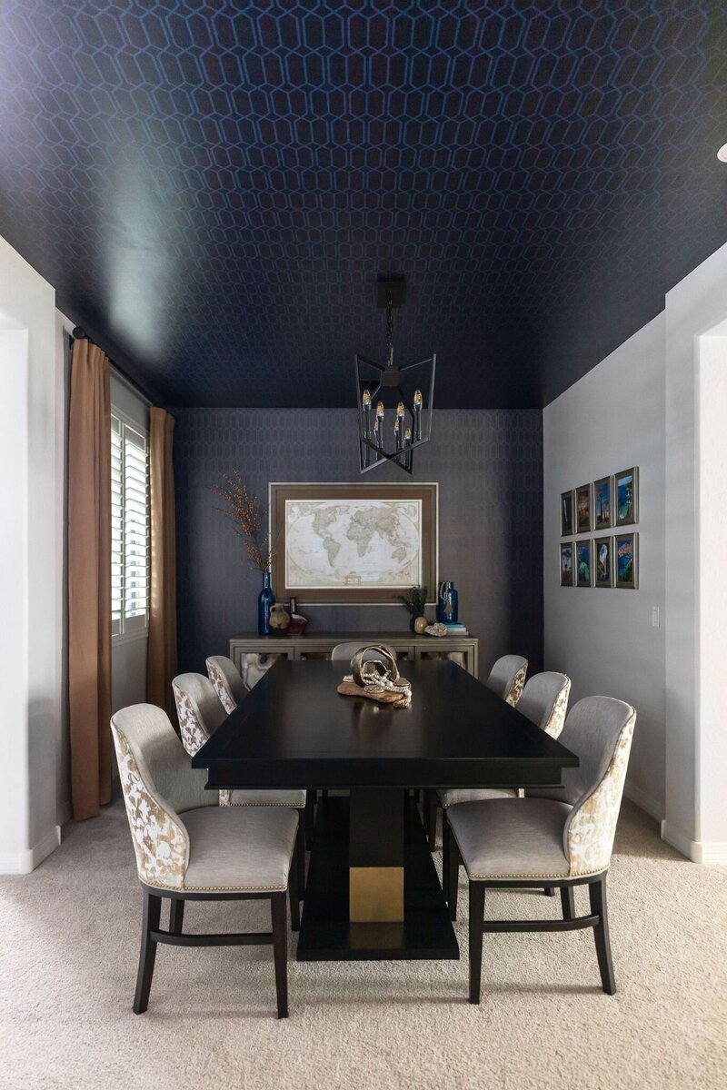 Modern dining room redesign in Peoria, AZ featuring custom wallpapered ceiling, tailored art installation, and layered neutral tones by Stuart Design Co.