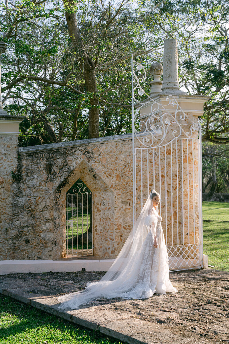 Stunning bride walks through elaborate gate on her wedding day