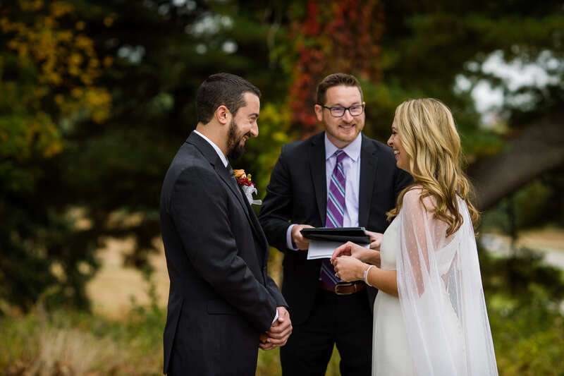 Couple exchanges vows with their officiant during an intimate elopement ceremony in Valley Forge Park.