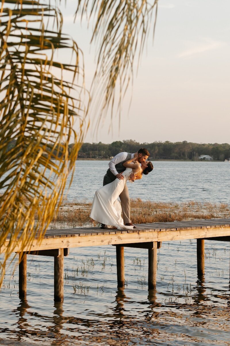 indie west photography portfolio image of bride and groom kissing on dock