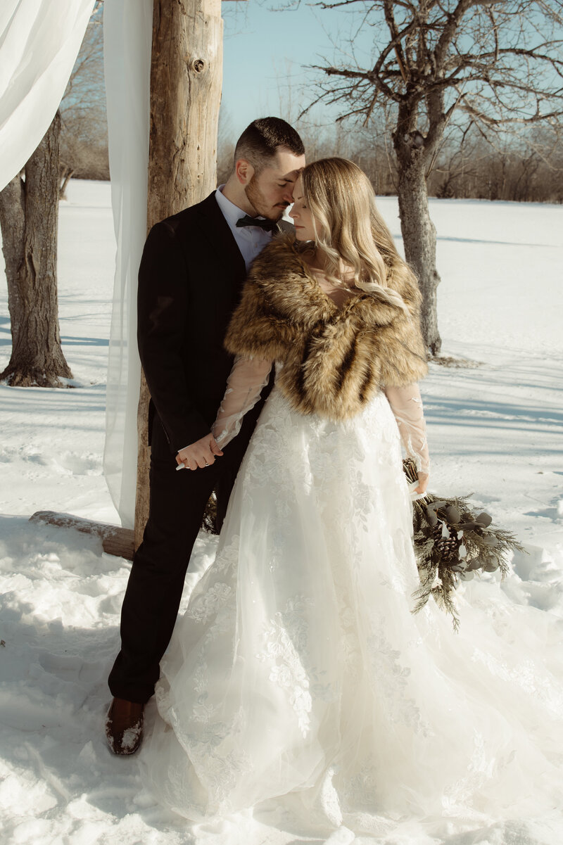 Wildhearted lovers exchanging vows in the snow