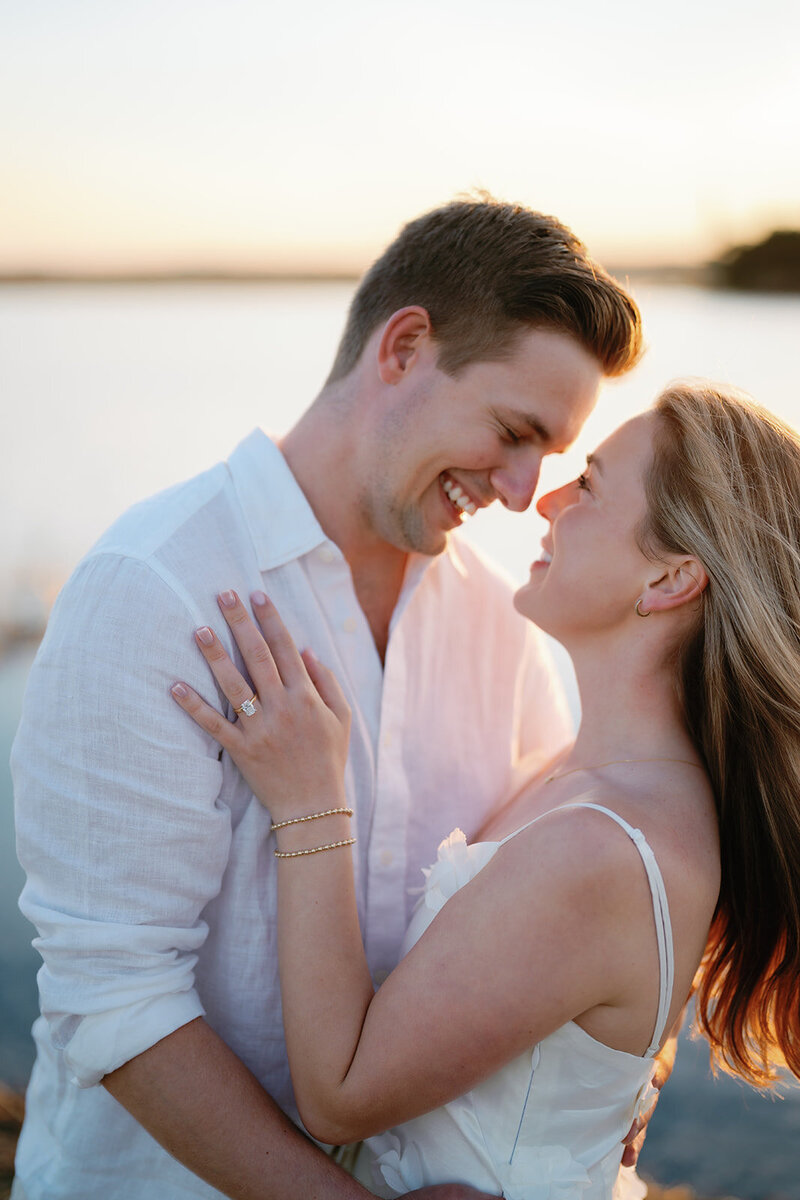 A couple embracing on the beach at sunset for engagement session in Ocean City, New Jersey