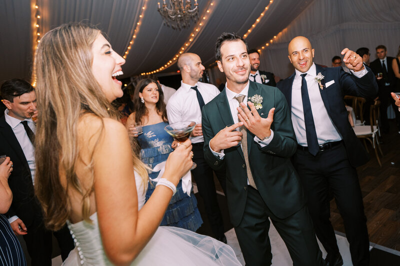 Maids of honor laughing on dance floor Glen Foerd Estate in Philadelphia, PA