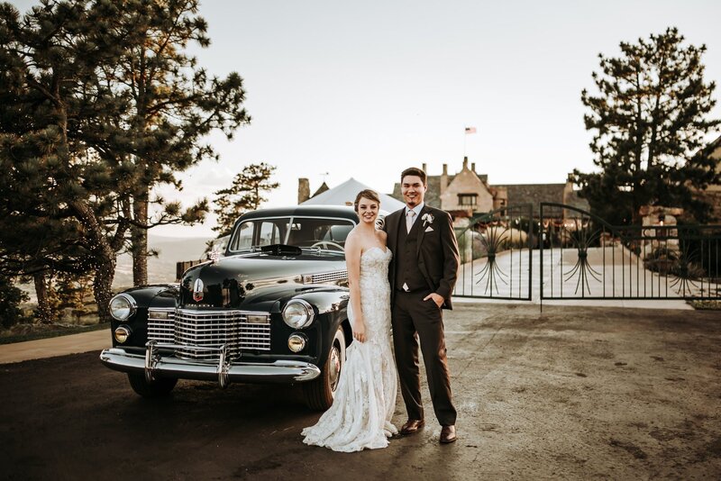 Bride and groom at Cherokee Ranch Castle with vintage car.