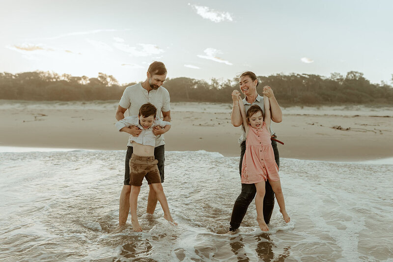 FLiz and Dan - family of four playing in the water at the beach-106