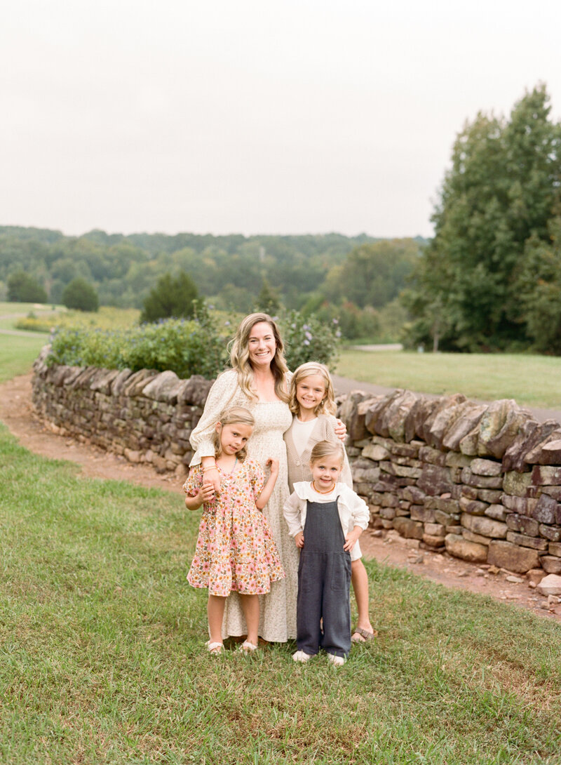 Image of Raleigh family photographer A.J. Dunlap Photography with her 3 daughters at Joyner Park in Wake Forest NC.