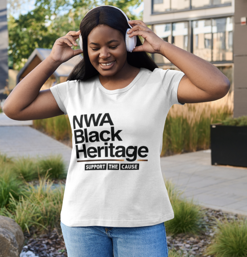 Woman wearing music headphones and a white t-shirt with the NWA Black Heritage logo on the front