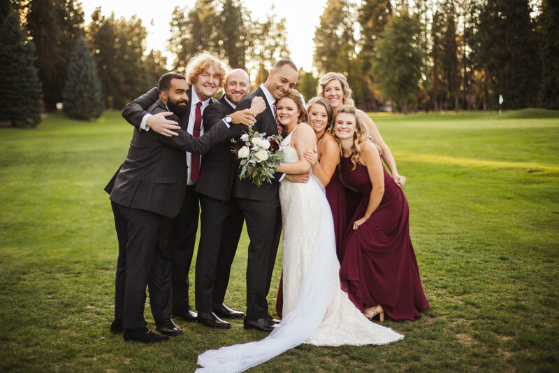 bridal party hugging and smiling during portraits