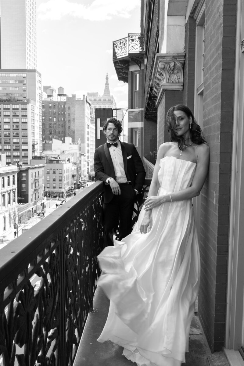 black and white editorial wedding photo of New York couple on balcony