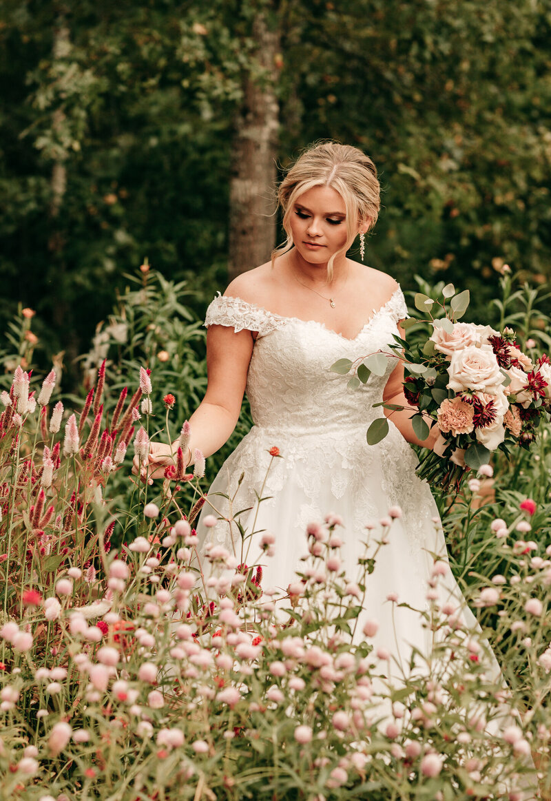 bride in cut flower garden at farm wedding venue in north ga