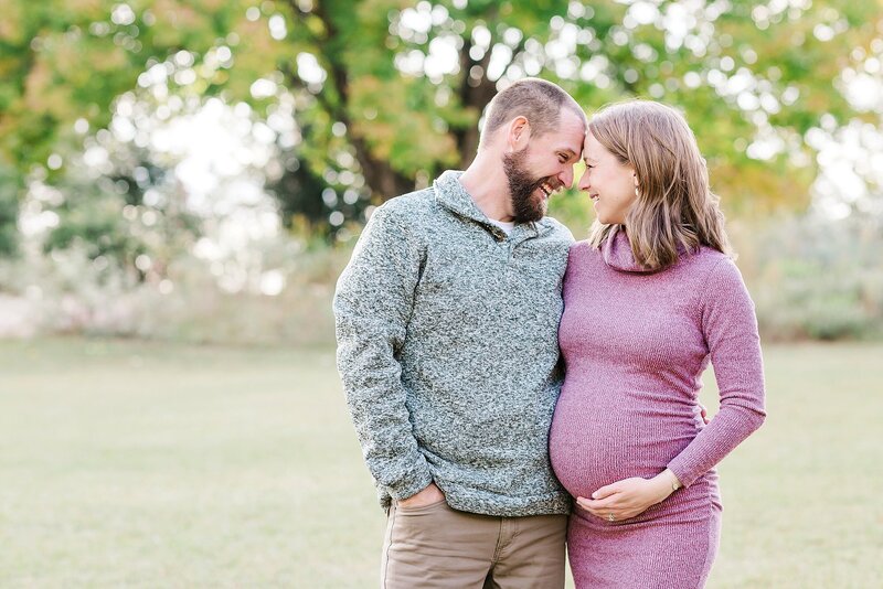 Mom and dad laughing together at Auburn AL maternity session