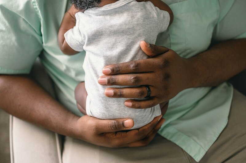 dad holding new baby at a Houston Newborn Photography session
