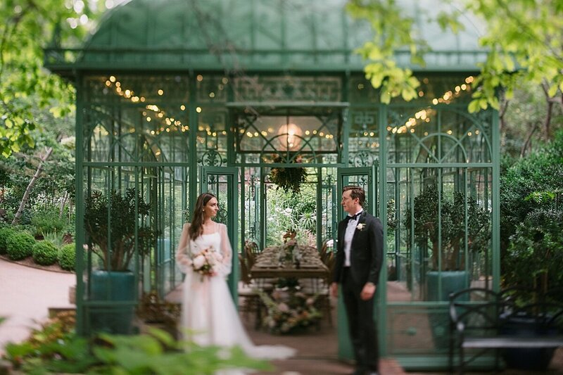 A Colorado wedding photographer takes a photo of a couple in downtown Denver