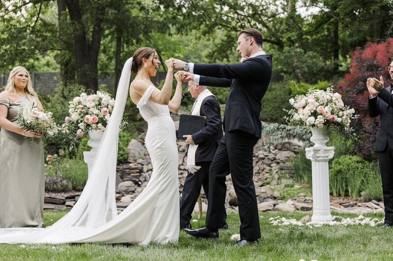 Ali and Alek laughing during their wedding ceremony in Saugerties