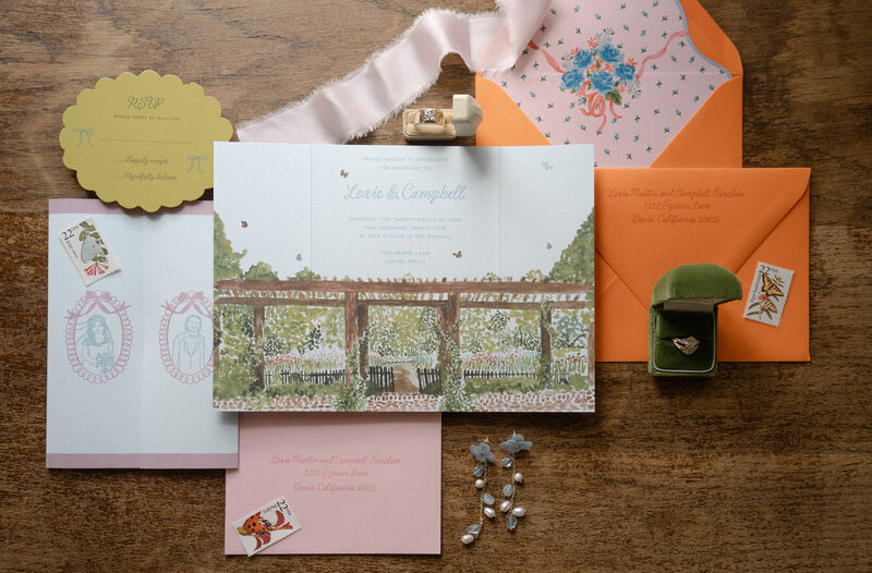 Colorful and modern stationery flat lay with RSVP card, custom watercolor invitation, and custom watercolor envelope liner
