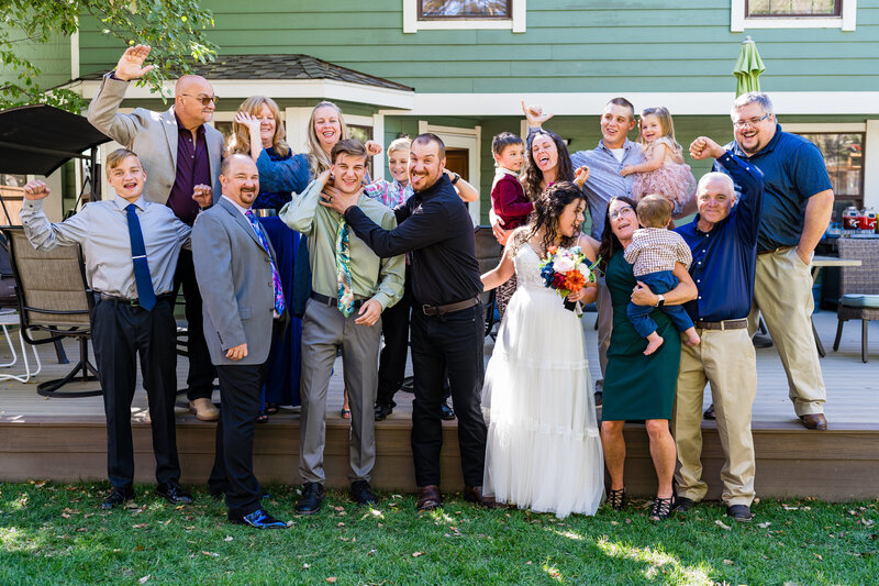 “Playful group photo from a Centennial micro-wedding with the entire family goofing off, captured by a fun and candid Colorado micro-wedding photographer