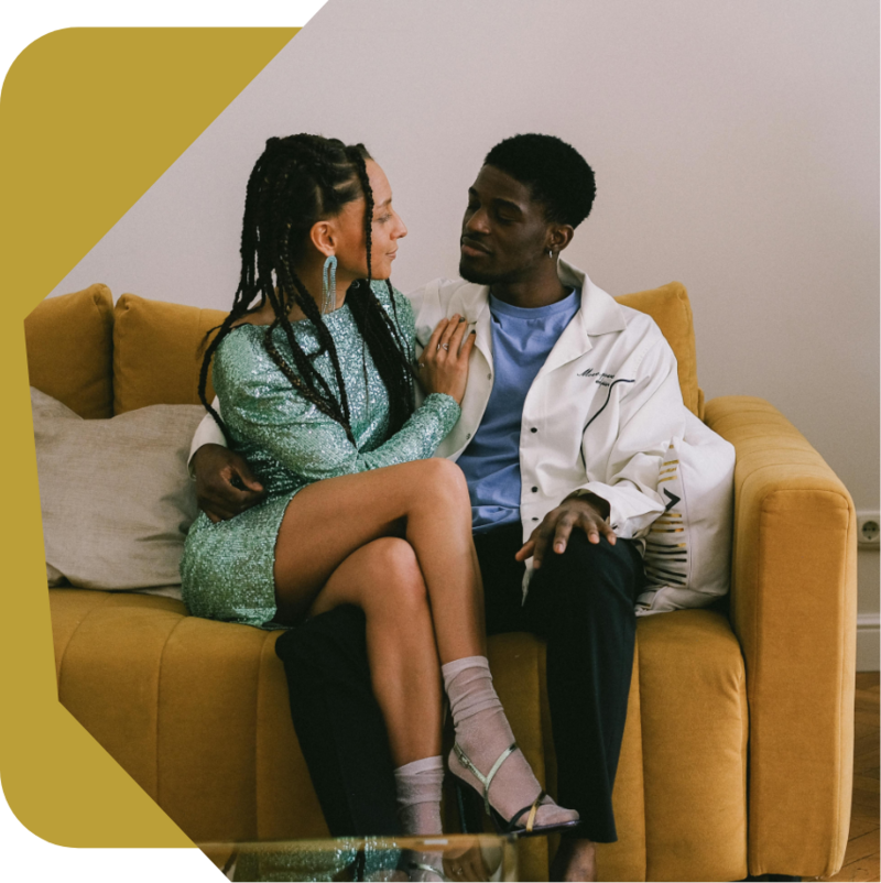 relationship therapy patients laying on a yellow couch looking at each other