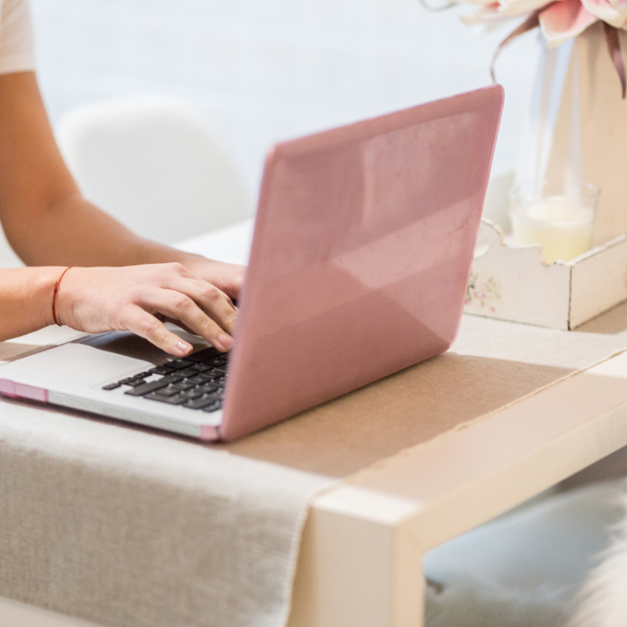 Woman using laptop to access Healing Habits online program for MS support and consistency with nutrition, movement, and mindset.