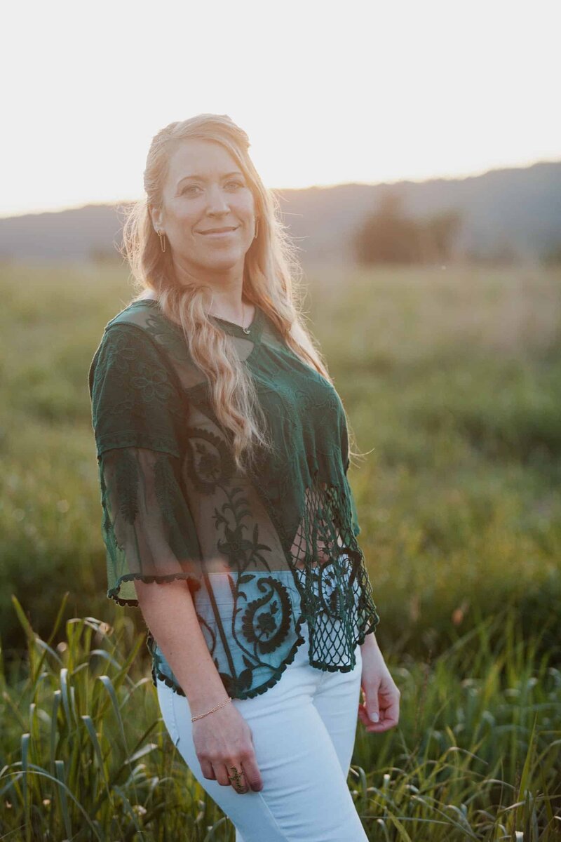 Kristin Hummel leaning against a fence