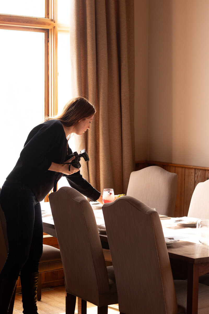 Marie-Catherine setting a table for a food photography shoot