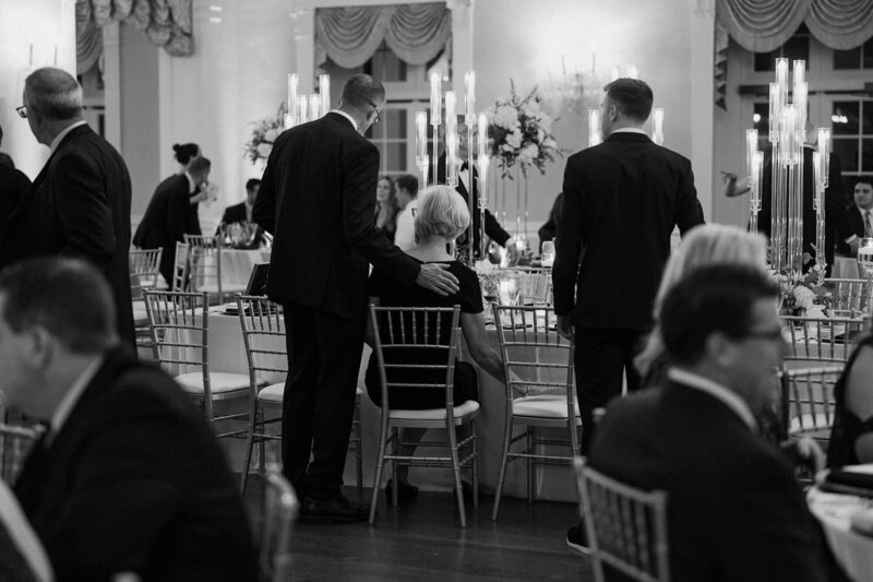 Guests walking around tables at a wedding reception 