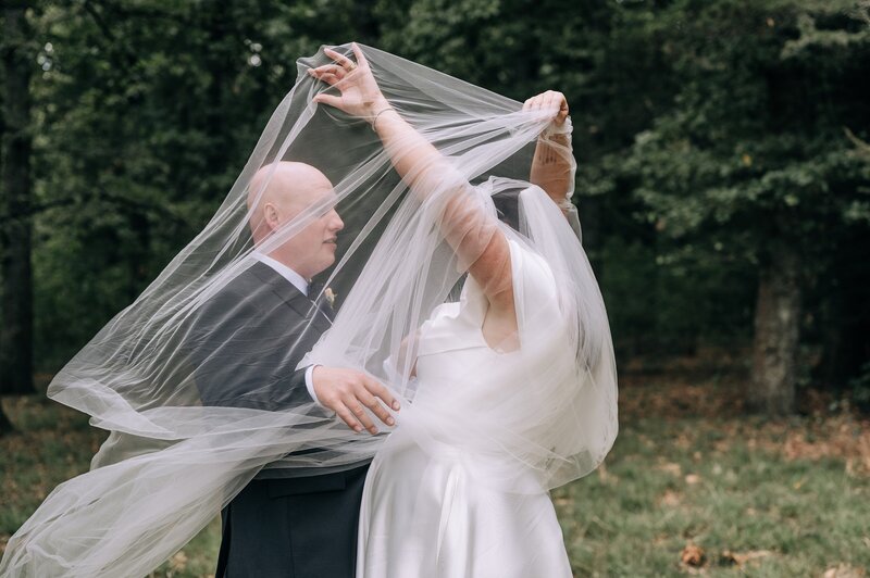 bride lifts veil over head on her wedding day in darfield at bangor farm