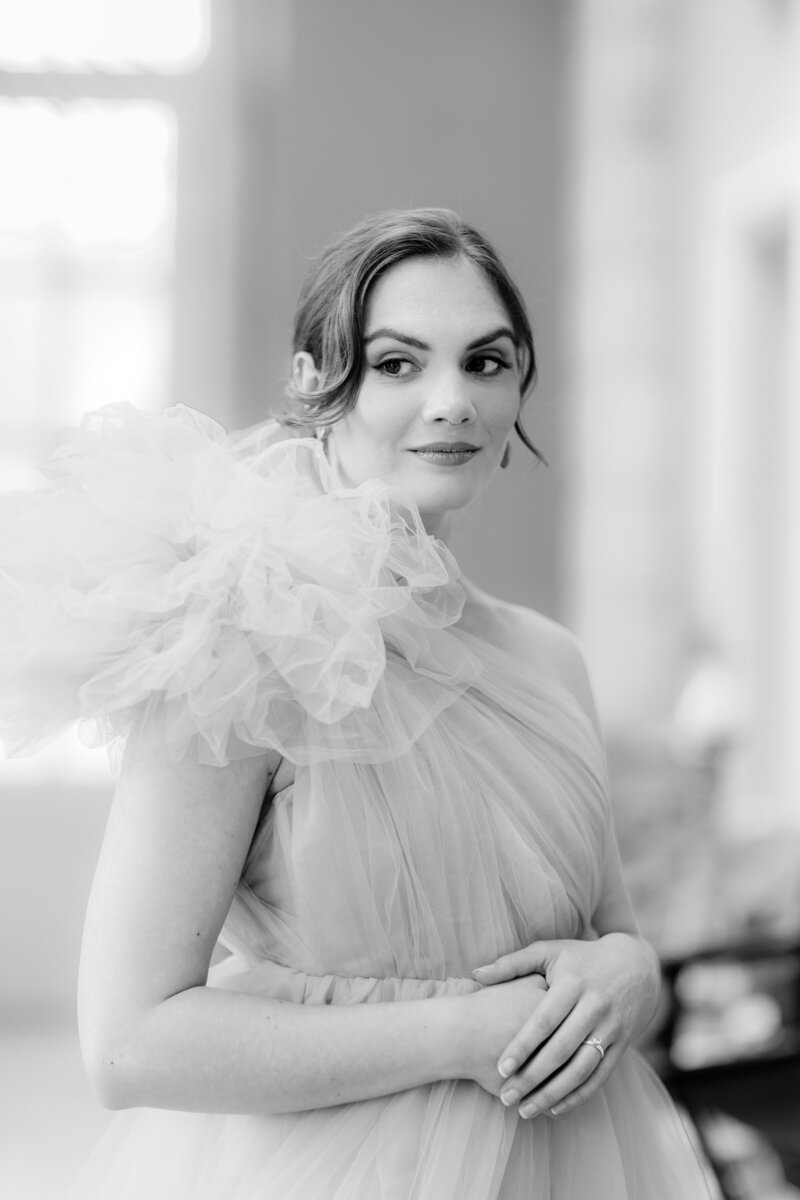 Elegant black and white bridal portrait of bride in purple Millia London dress with puffy shoulder, looking to the side., photographed by adorlee