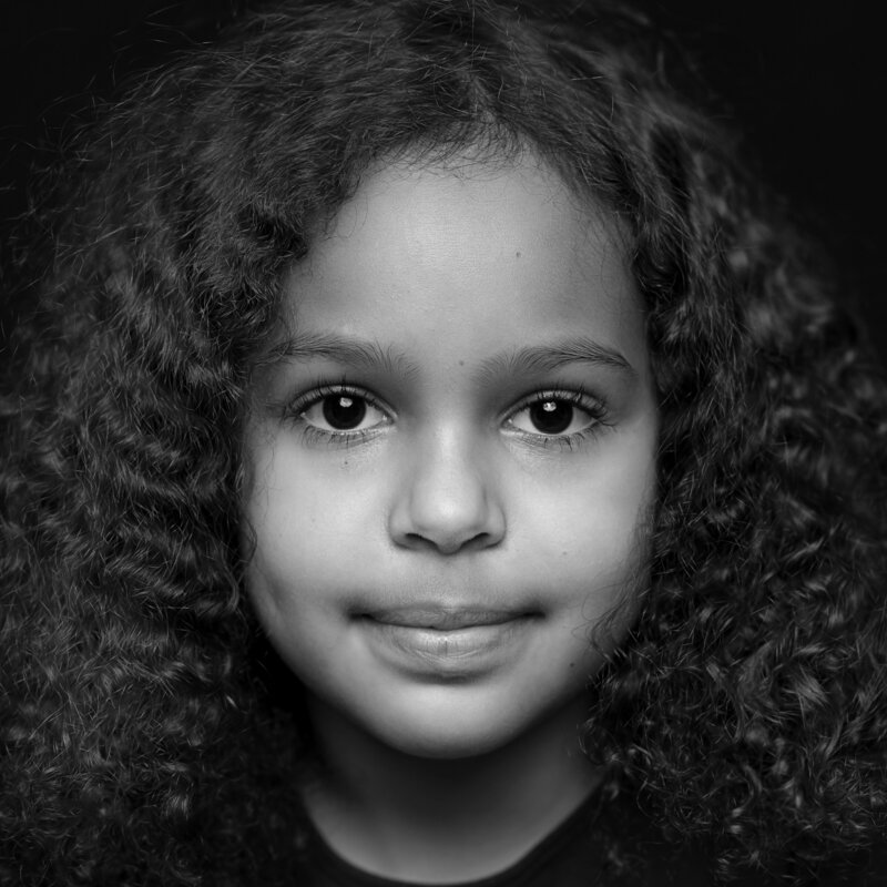 closeup black and white portrait of young african american girl with curly hair